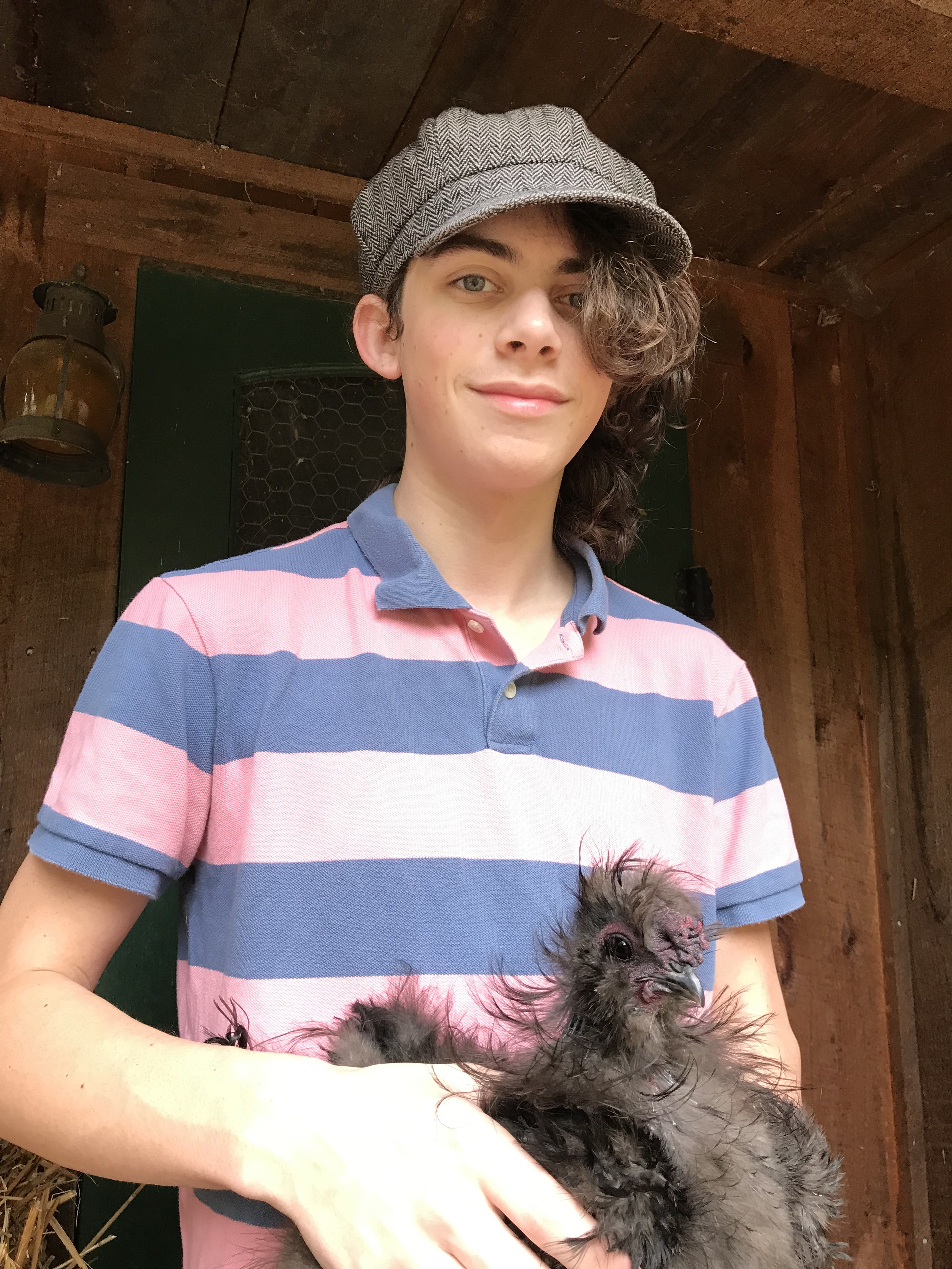 Image of Max holding her chicken Mr. Jack. Max is smiling and Mr. Jack looks perplexed.